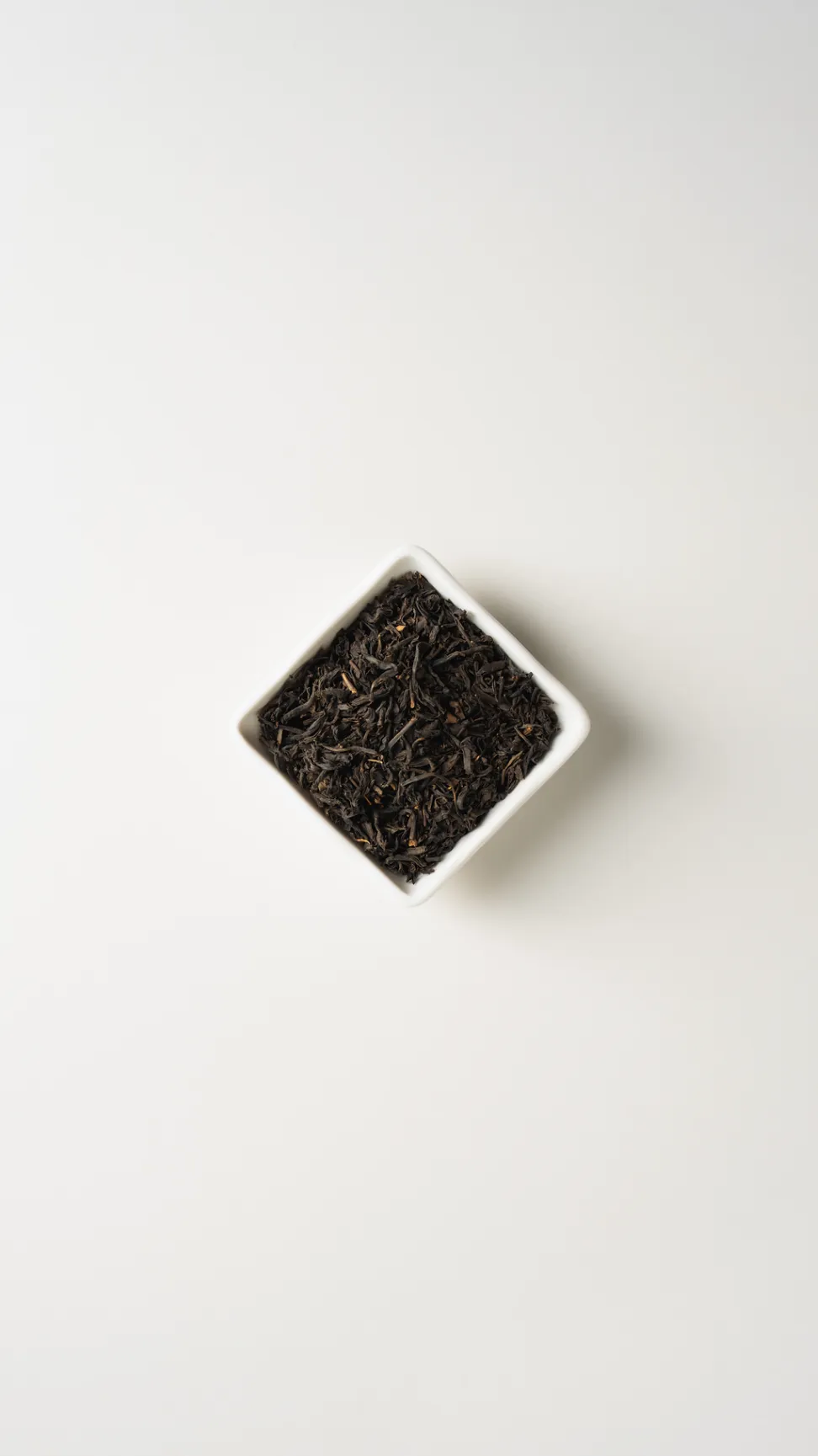 Timeless Grey loose-leaf tea in a white square dish on a clean near-white background.